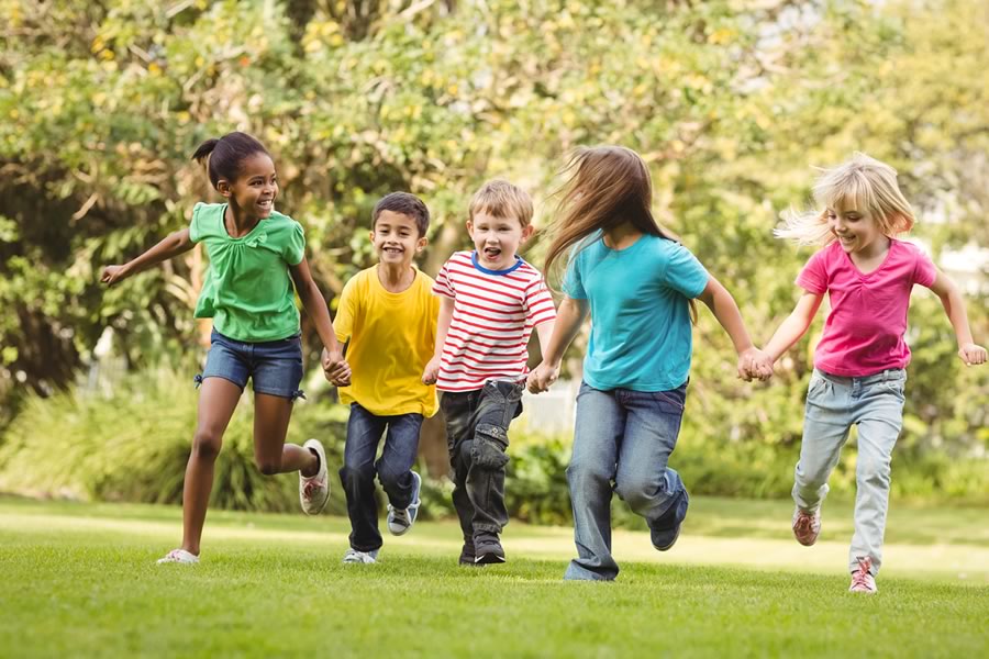 Healthy children running through park