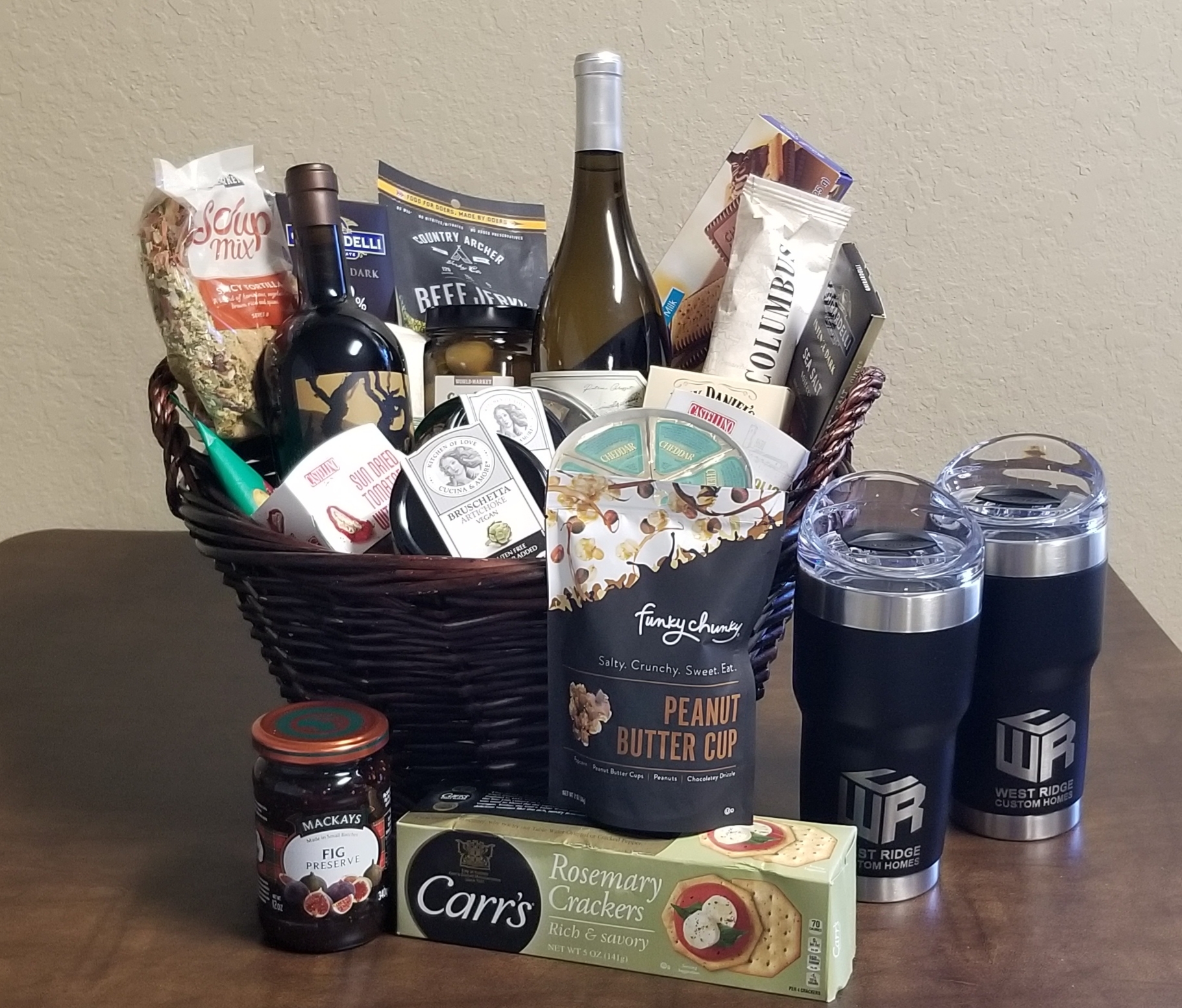 Online Secret Auction: Wines (2), charcuterie and chocolates, Pelican Travel Tumblers (2) w/slide lids presented in a decorative wicker basket